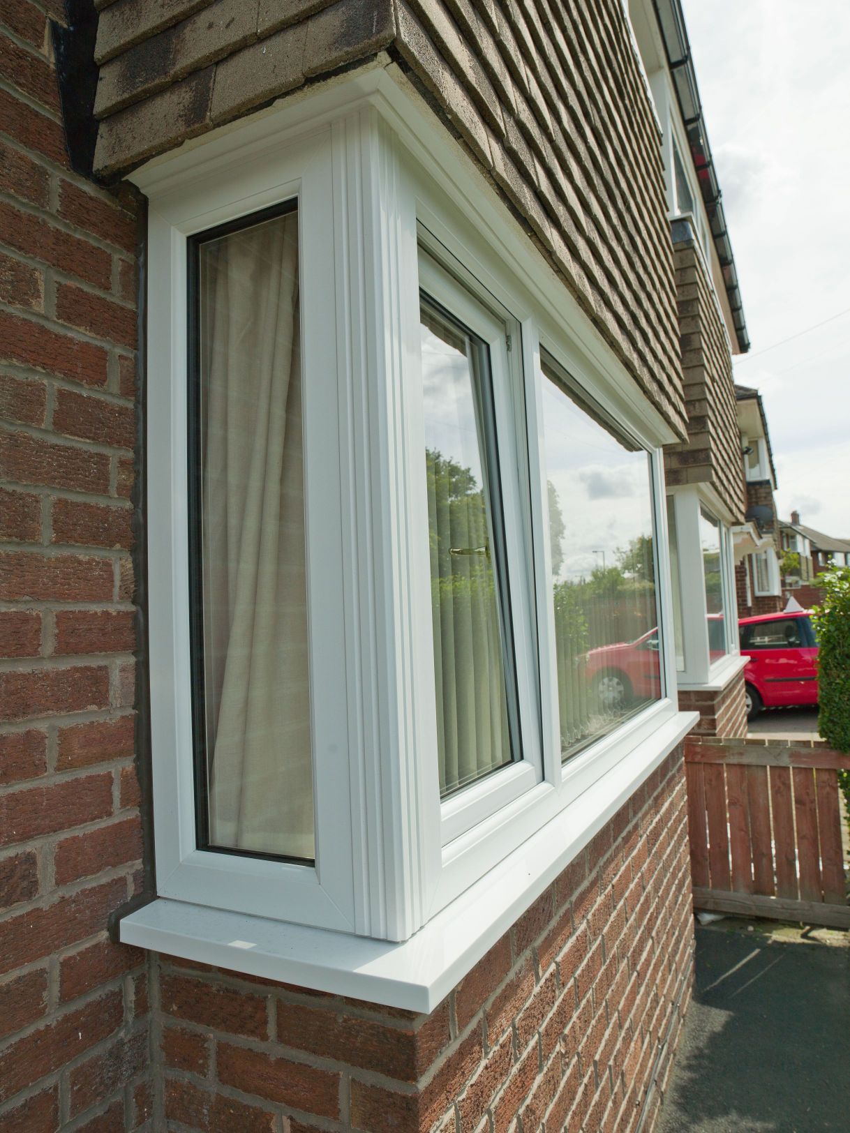White uPVC tilt and turn corner window fitted to a red-brick Southampton home