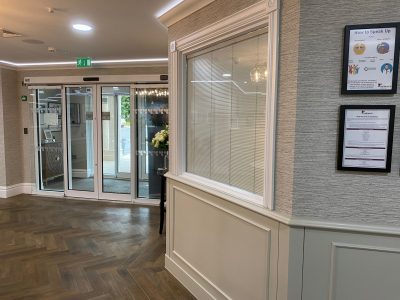 Integral blinds visible in a commercial entrance lobby window